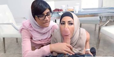 Two busty Arab ladies share a hard cock on the couch